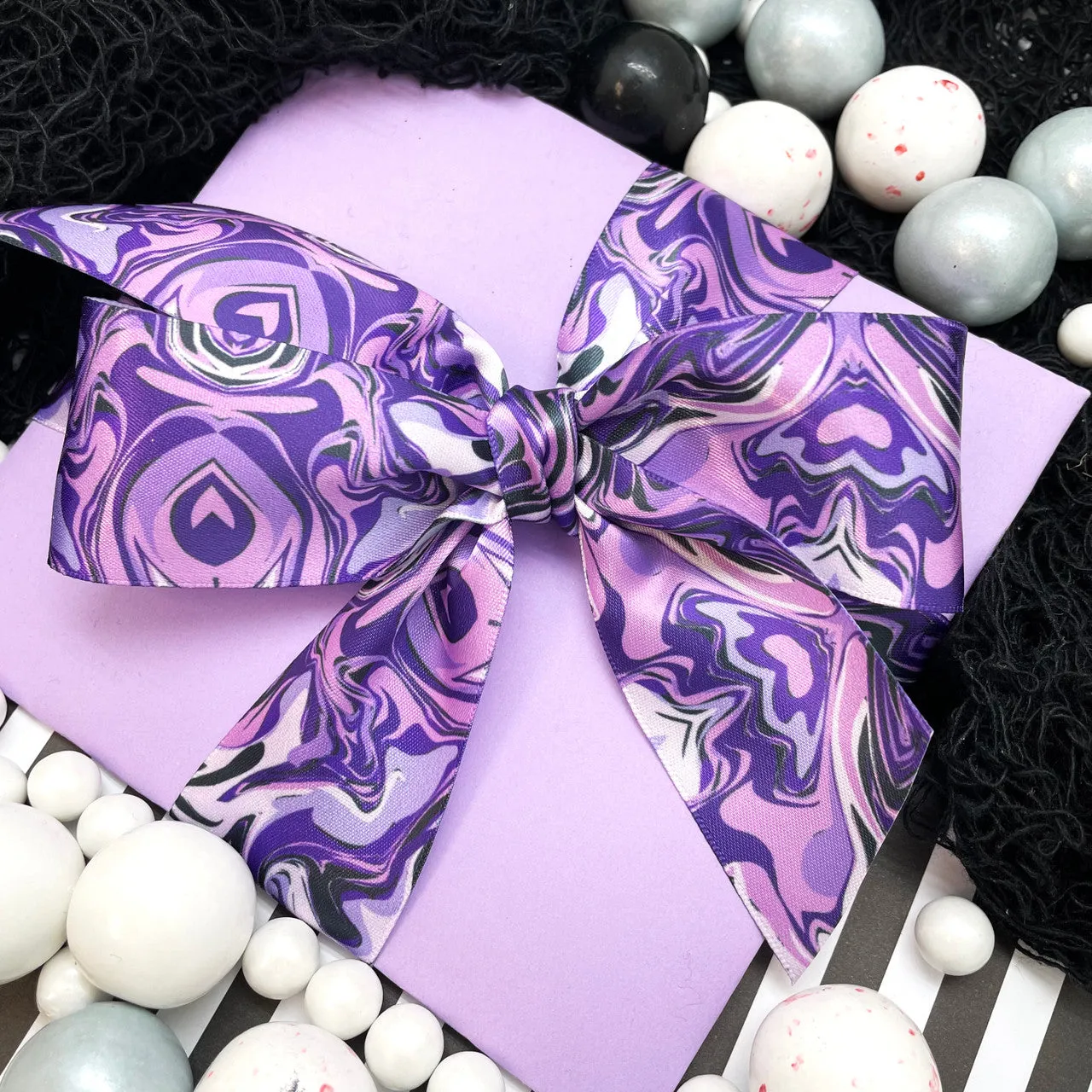 Purple marbled ribbon in shades from deep purple to lavender printed on 1.5" white single face satin